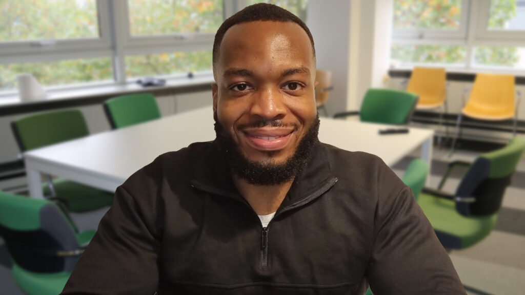 Staff member Richard smiling in the office