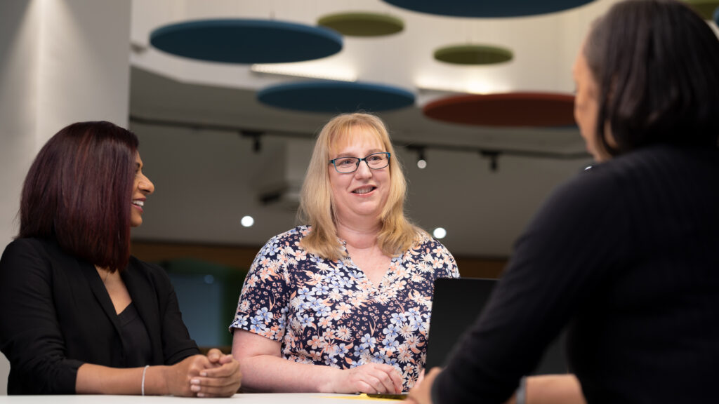 Three Female members of Home Office staff talking informally