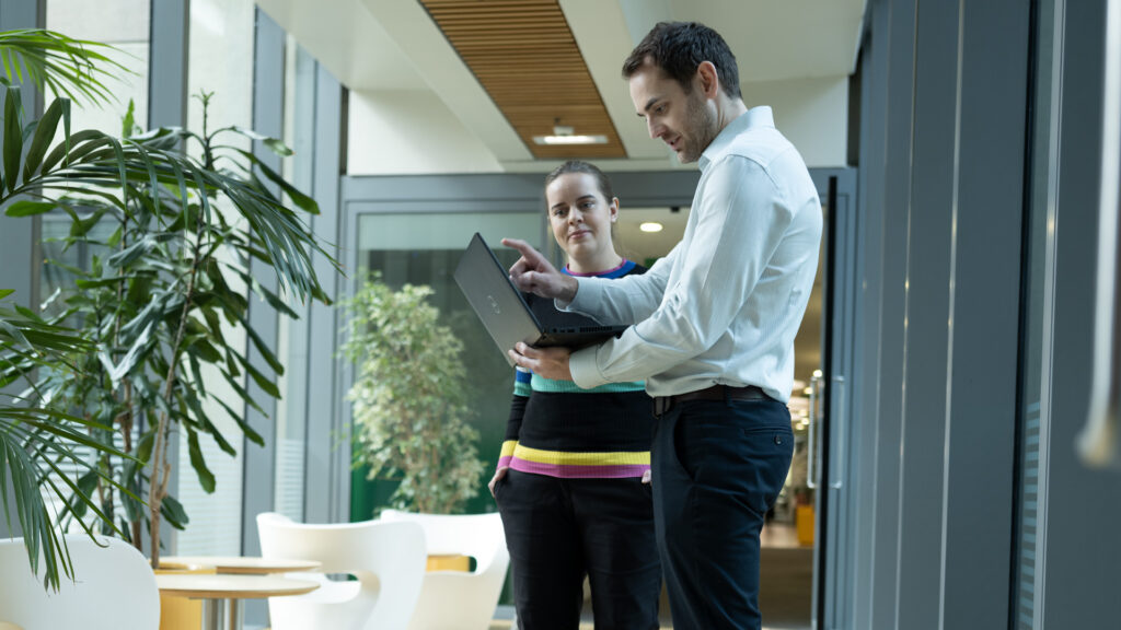 Two members of Home Office staff looking at a laptop