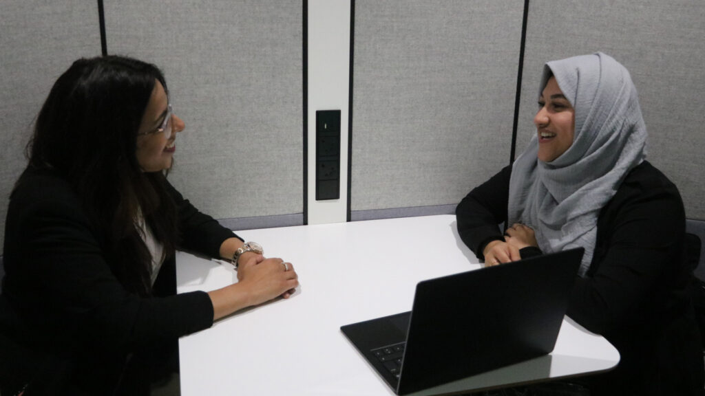 Two female members of staff in an informal meeting