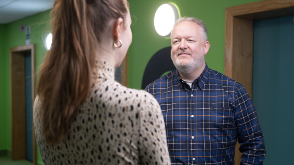 Male and Female members of staff chatting