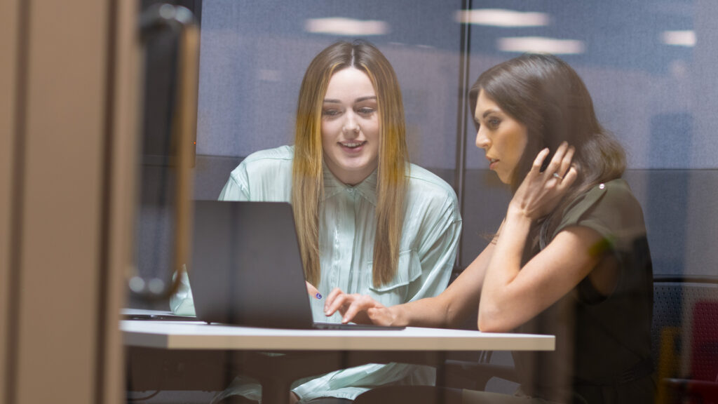 2 female members of Home Office staff at a laptop